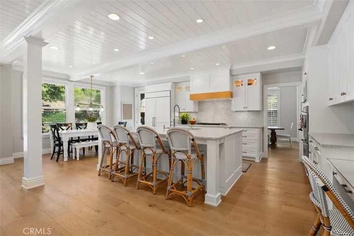 Plenty of seating at the solid marle center island.  The rich hardwood add warmth and charm!!