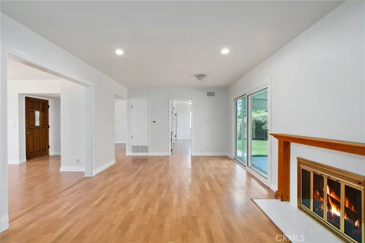 without virtual staging ** A separate family room offers an ideal setting for gatherings, complete with a cozy fireplace and a newer sliding glass door that frames peaceful views of the beautifully landscaped backyard.