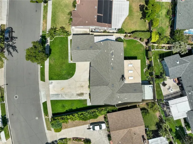 Situated on a wide, private street in a quiet neighborhood, this home rests on an expansive 7,300+ square foot lot. The front of the home offers fantastic curb appeal, enhanced by a long, curved driveway leading to a direct-access two-car garage—perfect for multiple vehicles or guests.
