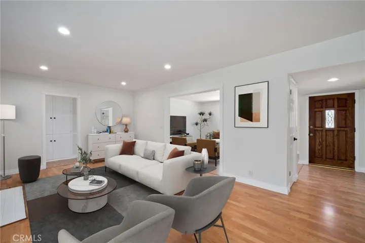 From the moment you step inside, you’re welcomed into a large, light-filled living room adorned with rich hardwood flooring and freshly painted interiors that create a warm, move-in ready atmosphere.