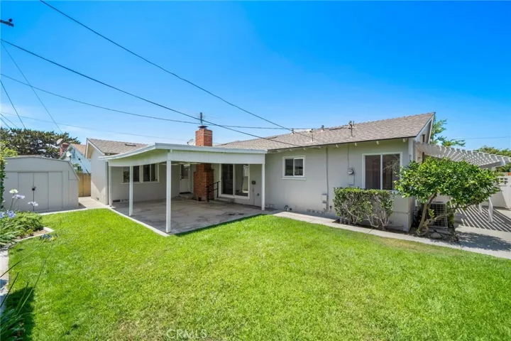 Step outside to a large, private backyard designed for relaxation and entertaining with covered patio