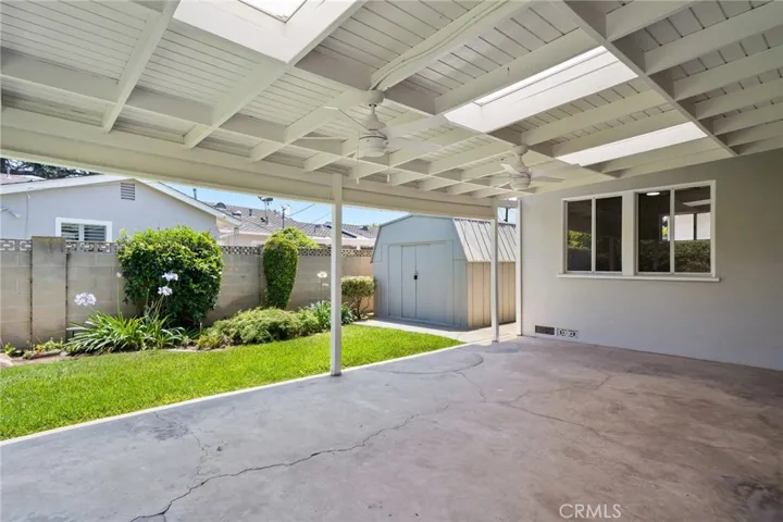 Enjoy al fresco dining under the covered patio, play on the expansive grassy area, or make use of the storage shed for tools and gear.