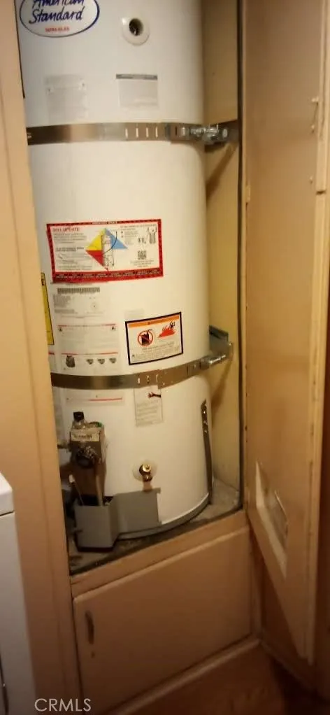 American Standard Dura-Glas water heater in laundry area.