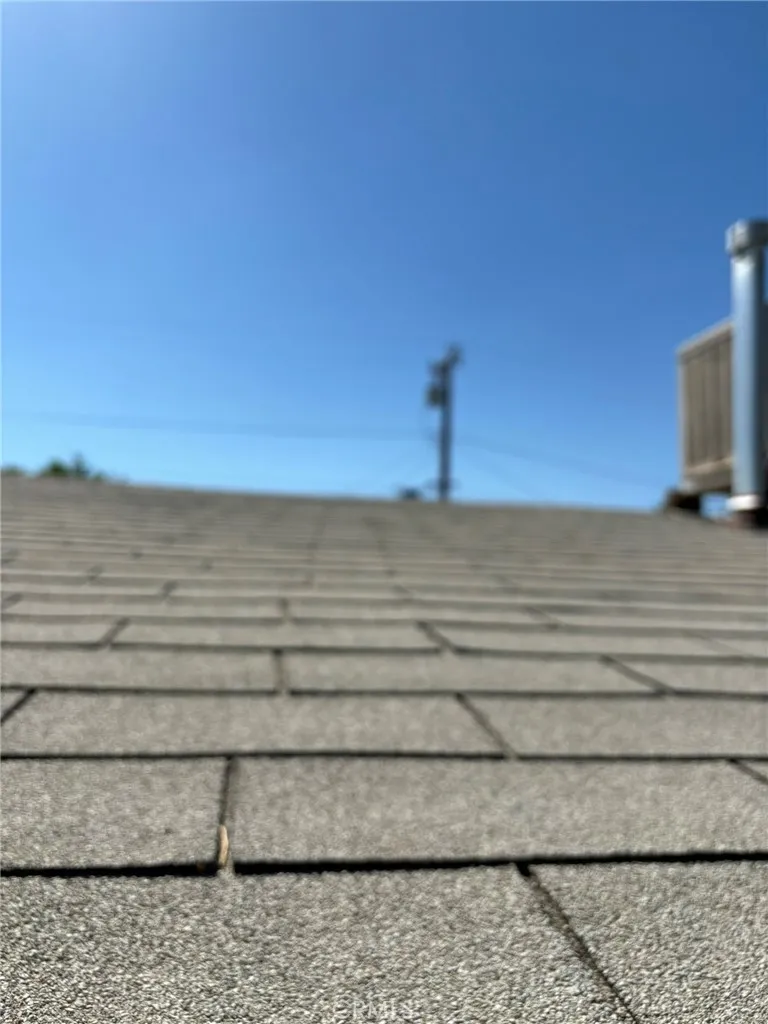 Close-up view of composite shingle roofing. Photo captures general surface condition.