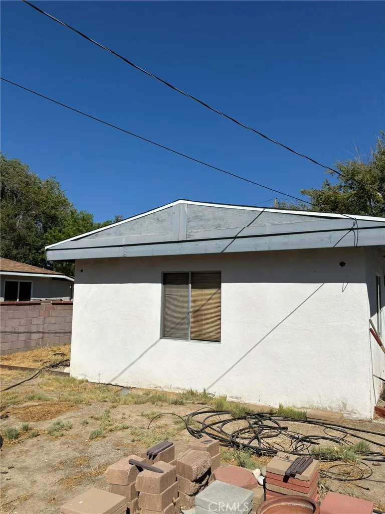 Rear exterior of bonus room with window view and surrounding yard area. Photo shows backyard space with open potential.