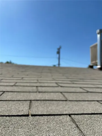 Close-up view of composite shingle roofing. Photo captures general surface condition.