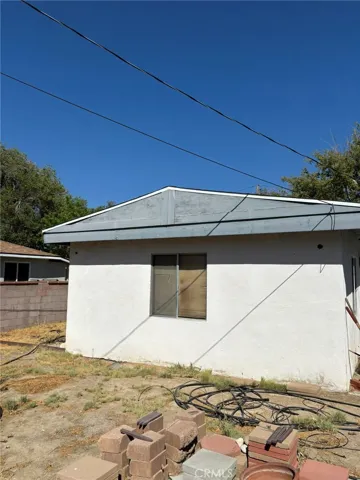 Rear exterior of bonus room with window view and surrounding yard area. Photo shows backyard space with open potential.