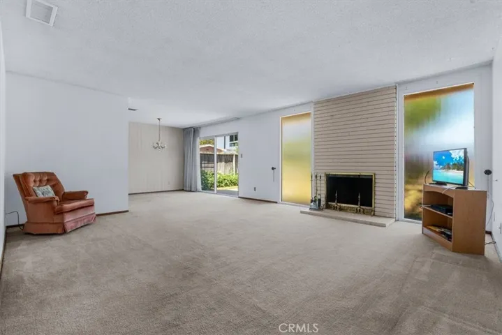 The open Living and Dining Rooms'  mid-century style with large windows invites many design options.