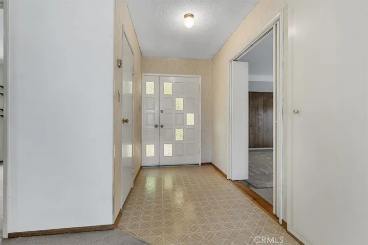 Entry hall leads to Living Room ahead and Family Room to left