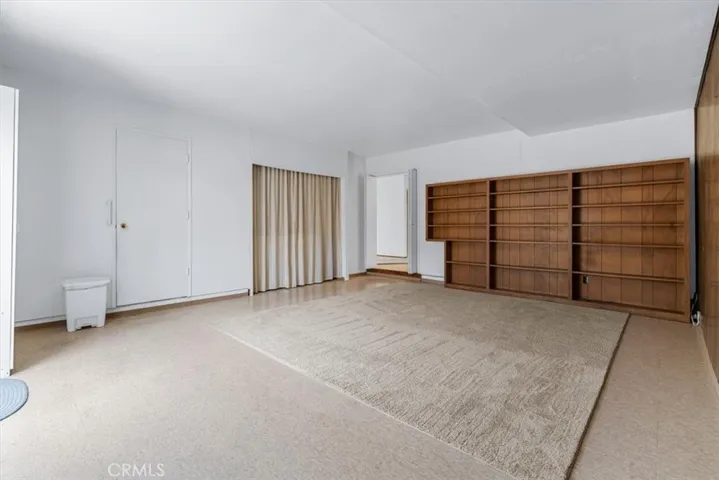 Family Room features a wall of shelving for books, collectables, or decorator items.