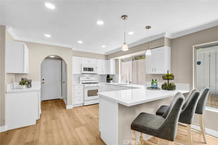 Beautiful kitchen with eating counter bar with seating.