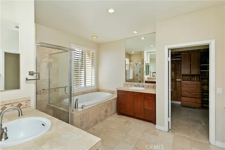 Primary bath with soaking tub, separate walk in shower, dual pullmans and spacious walk in closet