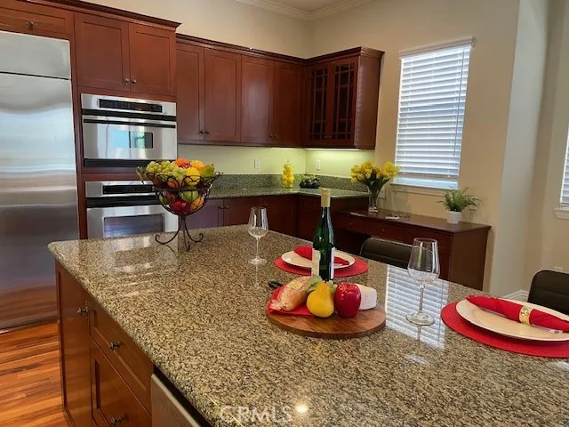 Rich wood cabinetry, granite countertops, microwave, oven and brand new refrigerator and freezer
