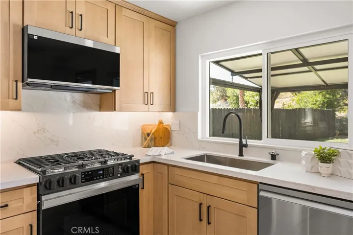 Slide in range and fully vented microwave
