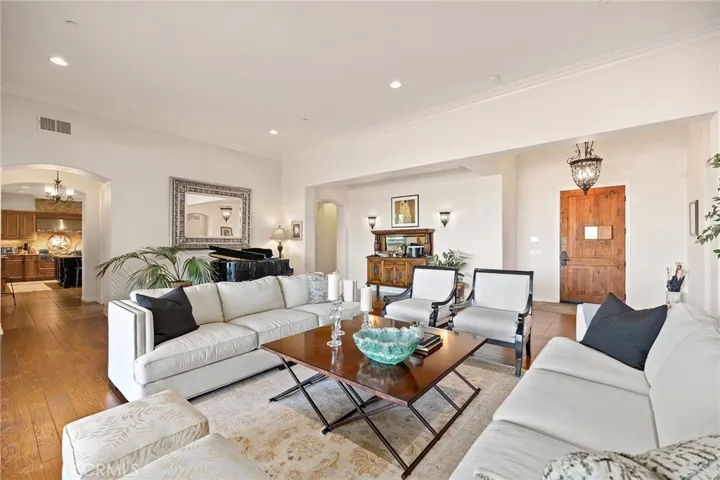 Formal Living Room with Hardwood flooring and high ceilings.  The piano is placed where a large dining room would typically be placed.