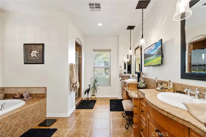 Elegant Bathroom in Primary Bedroom, with double sinks, vanity, separate soaking tub and shower