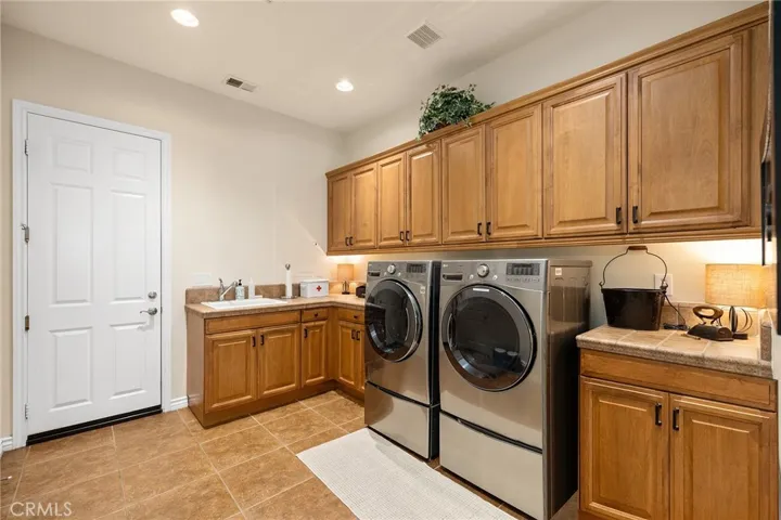 Huge Laundry room with extensive storage cabinets.
