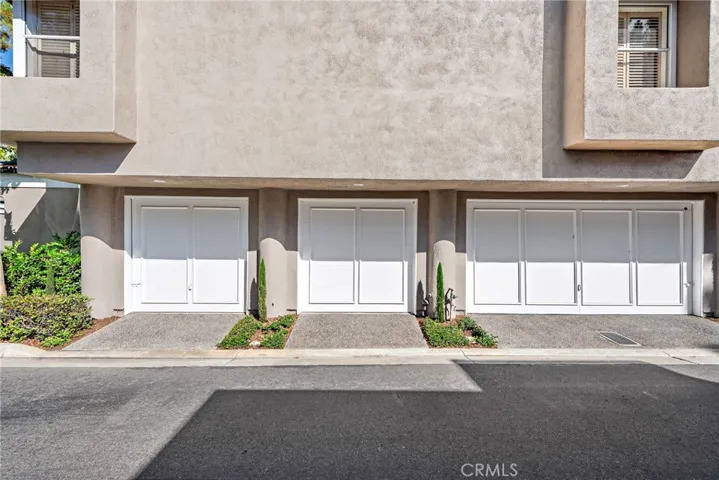 The attached single-car garage is the middle one, offering direct access to the kitchen for added convenience.