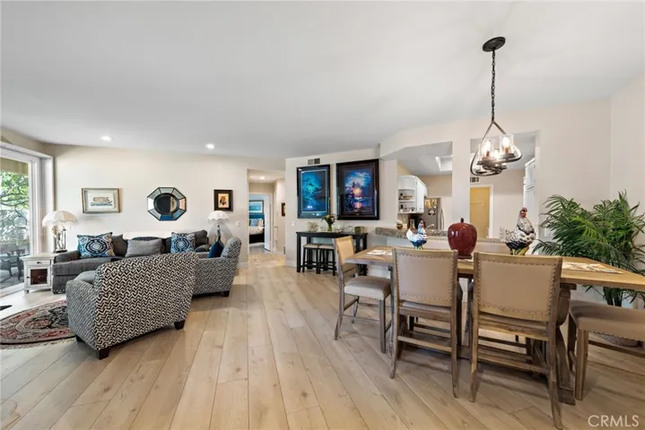 Flows effortlessly from the dining space into the living room, featuring a warm fireplace.