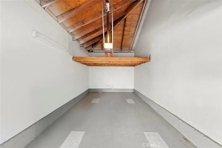 The detached garage features a clean, versatile interior—perfect for parking, storage, or a potential workshop.