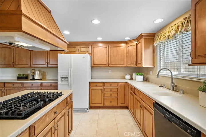 double ovens, dishwasher, and extended custom Maple cabinetry