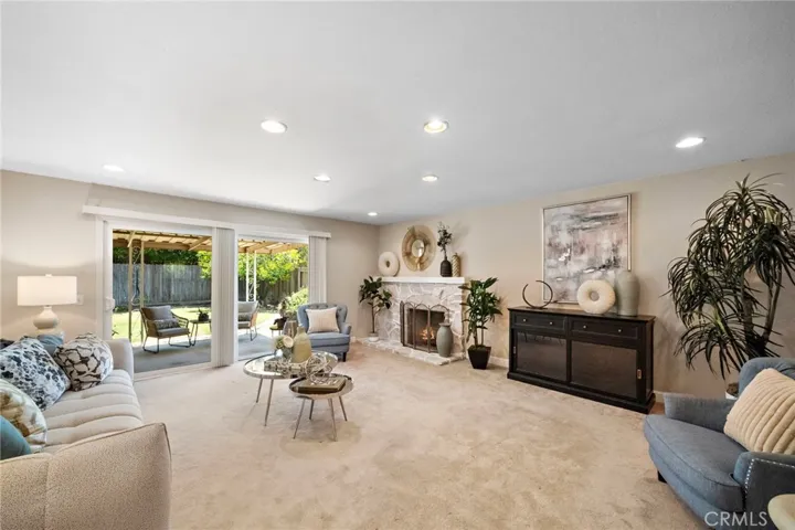  The spacious living room boasts a stone fireplace with raised hearth and sliding doors