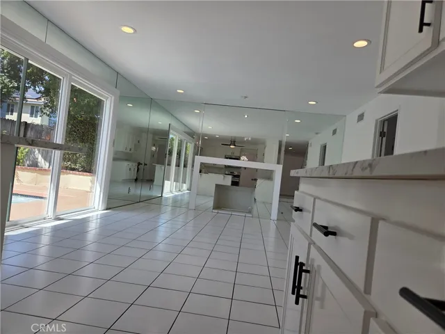Recessed lighting in family room and kitchen, tile flooring, fireplace in family room.