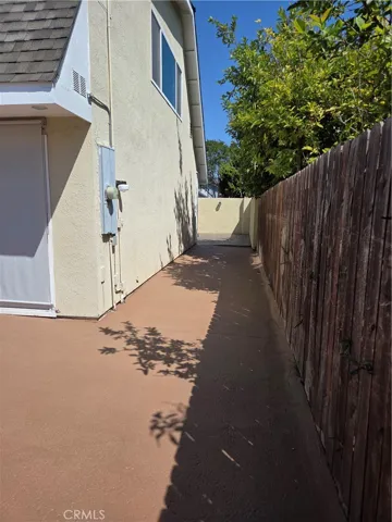 Side walkway leads to the enclosed private court yard