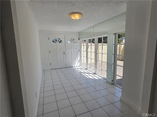 Foyer entrance with French Windows enhancing natural lighting into the house.  View of enclosed court yard