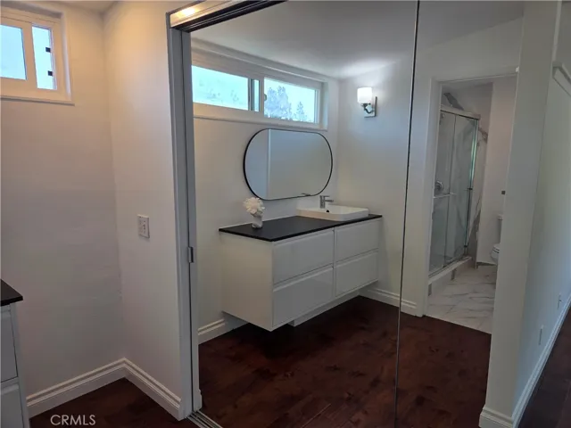 New sink vanity in primary bedroom and mirrored closet doors
