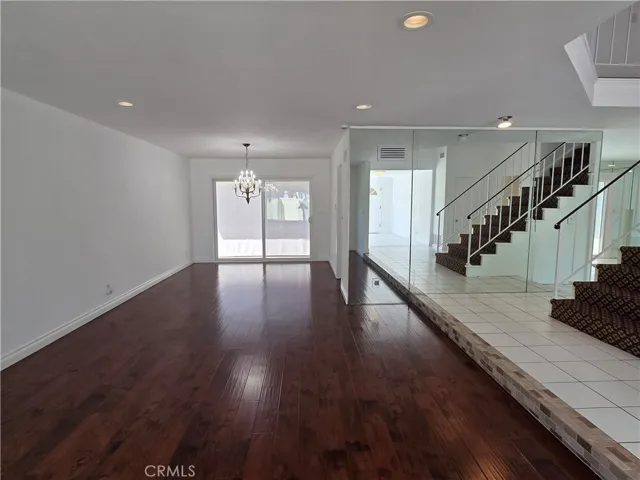 View of Spacious Living and Dining Rooms which cherry laminate flooring and sliding doors leading to the backyard