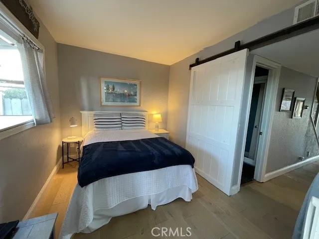 Main living area bonus room has double bed, includes glass slider to backyard.