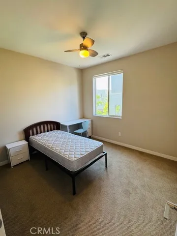 Bedroom with walk-in closet