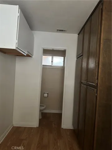 Laundry room at garage entrance with half bath and extra storage