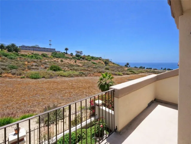 Balcony in Primary Bedroom looking out to the Ocean and Open Space