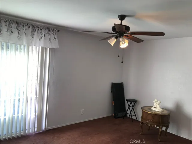 Primary bedroom view of fan and updated slider door