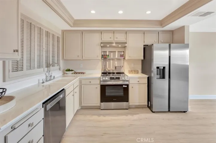 Refurbished kitchen - new dishwasher, new stove, new range hood, new backsplash behind stove, newer frig, refinish countertops, painted, new flooring, new knobs/pulls, new faucet