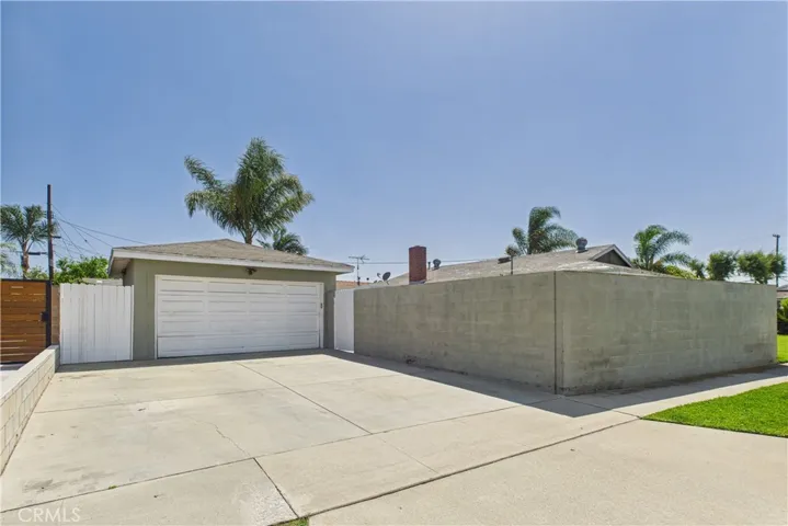 driveway has gate that leads to backyard