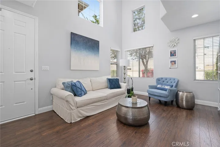 Step inside to a bright and inviting living space with rich laminate flooring and neutral paint tones.