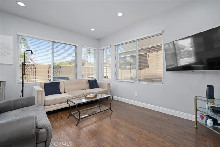 Flooded with natural light from large windows and a sliding glass door to the backyard.