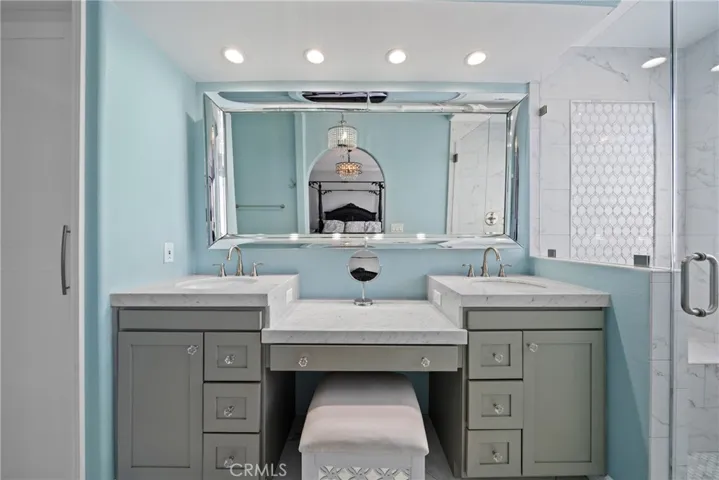 Enjoy daily spa vibes in your remodeled en-suite bath featuring dual sinks and marble countertops.