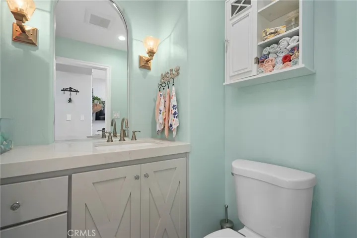 Modern vanity, tasteful fixtures, and designer finishes elevate this half-bath.