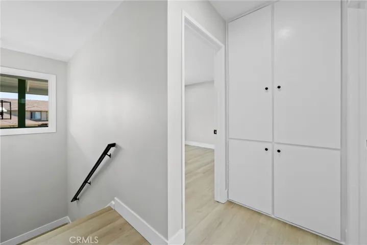 Heading upstairs, the hallway offers a clean, bright path to all bedrooms and bathrooms.