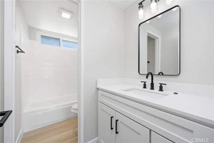 Remodeled upstairs hallway bathroom with tub/shower combo.