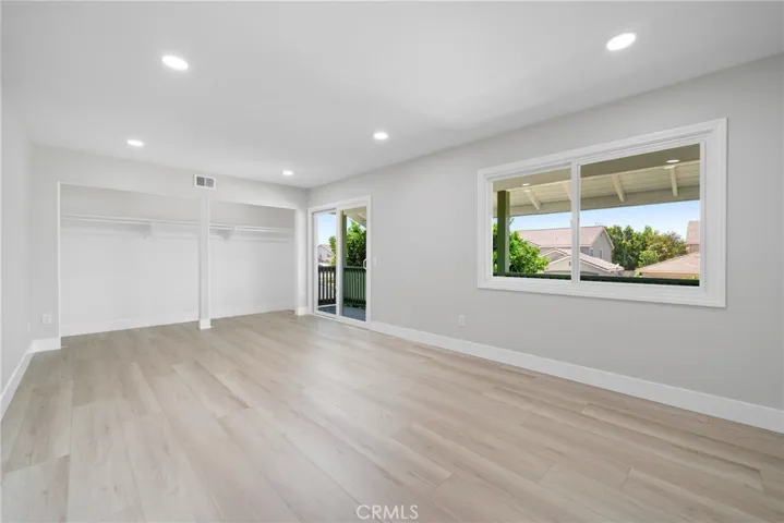 Upstairs bedroom offers ample space and flexibility—potential to create a fifth bedroom.