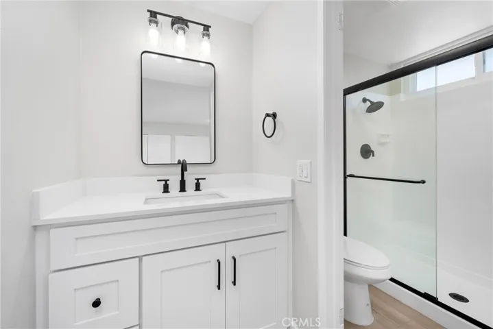 The en-suite master bathroom features a step-in shower and modern finishes.