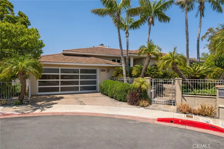 Additional highlights include hardwood floors, central air conditioning, and a two-car garage with contemporary glass door and built-in storage.