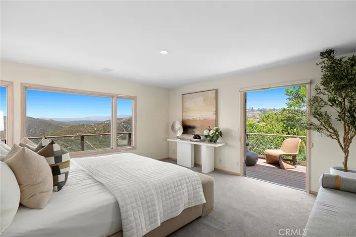 The primary suite is a serene retreat with French doors to a private patio, ocean views