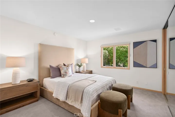 Two additional bedrooms—one with patio access—offer flexibility for guests or a home office