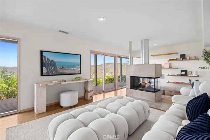  On the lower level, a spacious family room with fireplace and deck access invites relaxed living and entertaining.